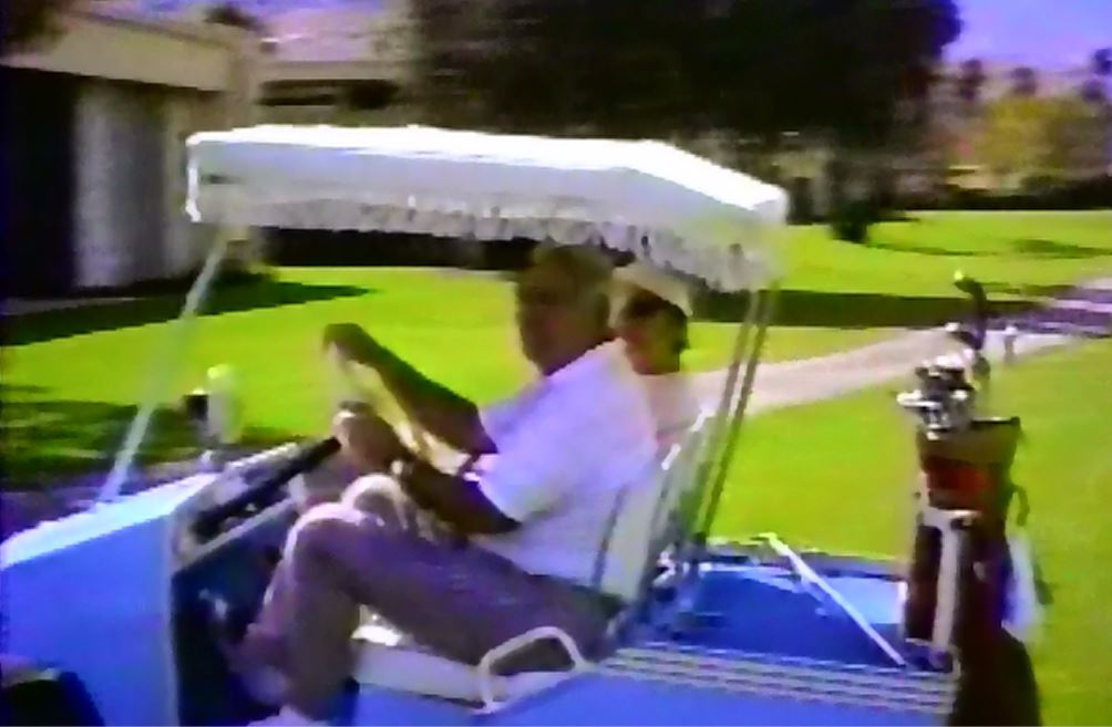 Myndal and Gilbert in Golf Cart